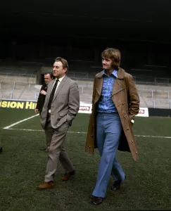 Footballer Rodney Marsh walks around Maine Road with Manchester City chairman Eric
