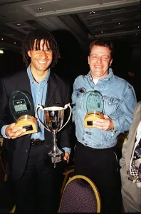 Former footballer Ruud Gullit (left) poses with Madness lead singer Suggs holding their