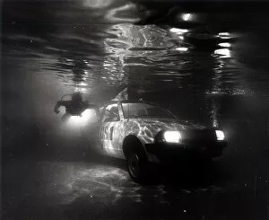 Images Dated 1st March 1981: A Ford Escort in a swimming pool tests a new water repelant lubricant spray