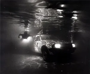 Weird Prints: A Ford Escort in a swimming pool tests a new water repelant lubricant spray