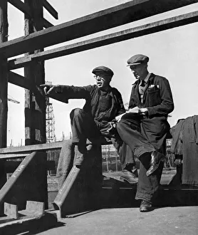 Dockyard Prints: Two foreman, upon whom the efficiency of any shipyard belongs, scrutinize, with shrewd