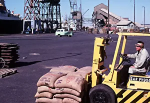 00134 Prints: Forklift truck loading fishmeal onto a ship at Docks Walvis Bay