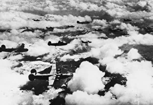 Formations of B-24 Liberator bombers of the 15th aF sweep over snow-capped mountains En