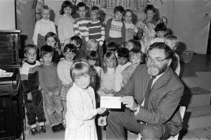 00684 Prints: Four-year-old Emily Sylvester presents a £300 cheque to National Society for