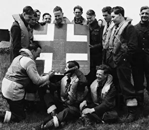 01424 Prints: A fragment cut from an enemy aircraft which the RAF squadron shot down is used for
