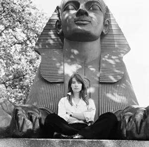 Francoise Hardy, french singer pictured seated between the feet of a sphinx