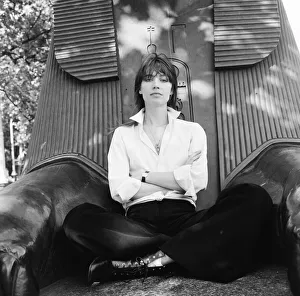 Francoise Hardy, french singer pictured seated between the feet of a sphinx