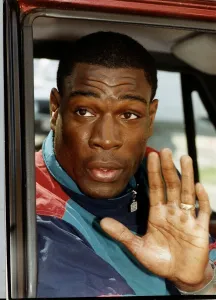 Frank Bruno boxer sitting in car waving