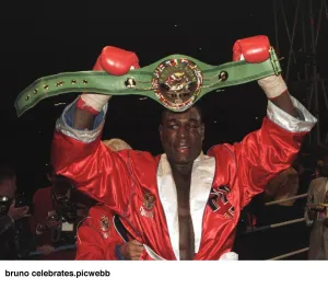 Frank Bruno celebrates after defeating Oliver McCall for the heavyweight title