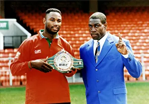 Frank Bruno with Lennox Lewis boxers Lewis holding WBC world championship belt at Cardiff