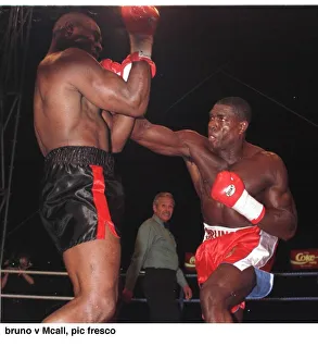 Frank Bruno strikes Oliver McCall with a right hook during their fight for