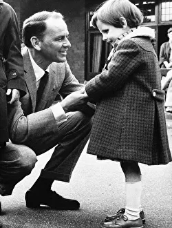 00141 Prints: Frank Sinatra Actor and Singer talking to a little blind girl at his visit to