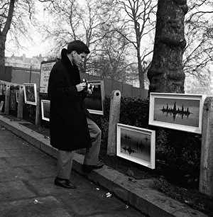 Frank Sinatra Junior in London January 1964 looking at painting displayed on fence