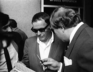 Frank Sinatra, signing autographs outside the Royal Festival Hall, London