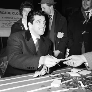 Frankie Vaughan March 1962 with some of the coins collected for the silver charity run