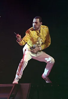 Freddie Mercury of Queen on stage, performing an air guitar. November 1989