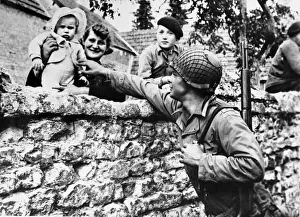 Greeting Prints: French civilians lean over their garden wall to greet an american solider of the allied