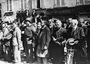 French civilians stand at attention and an American Army Gl salutes as the American