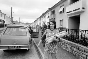 Domestic Life Prints: French housewife Mrs. Maria Quaranta after buying the days bread from the delivery car