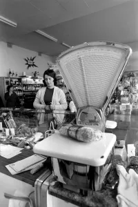 Weight Prints: French housewife Mrs Maria Quaranta looks on as her meat is weighed at the local