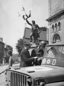 Local Prints: A French villager aids RAF traffic control policeman Corporal Syd Highens of Leicester