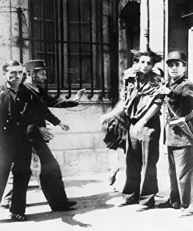 A French woman slaps a captured Gestapo agent who was the cause of her husband being