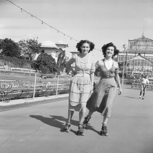 00964 Prints: Friends rolling skating in the August sunshine at the Winter Gardens in Great Yarmouth