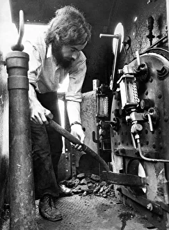 Shovel Prints: Fuel for the boiler of an old steam engine is shoveled on by Peter Weightman one of
