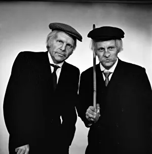 Fulham footballers Bobby Moore (left) and Alan Mullery dressed in suits and make-up