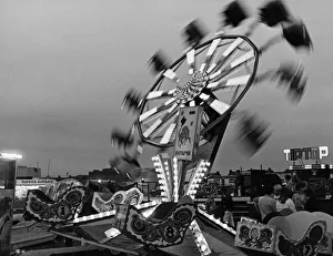 Fairground Prints: Fun seekers enjoying all the fun of the fair on the Octopus ride at the Clairville Common
