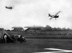 G. E. Lowdell flying in a Comper Swift (G-ABTC) leads Sq Ldr J. W