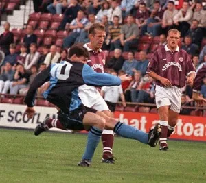 Hearts Prints: Gareth Hutchison Stenhousemuir football player shoots for goal as hearts players Gary