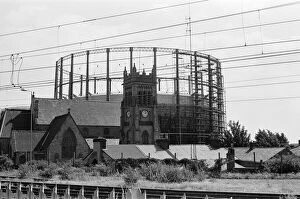 Images Dated 16th August 1988: Garston Gasometer, dwarfs church in foreground, Liverpool, Merseyside, 16th August 1988