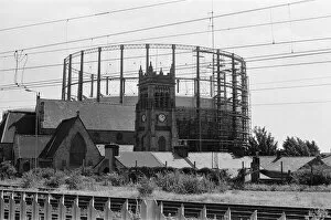 Images Dated 16th August 1988: Garston Gasometer, dwarfs church in foreground, Liverpool, Merseyside, 16th August 1988