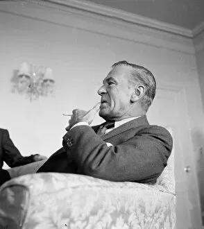Gary Cooper in London smoking a cigarette- April 1955