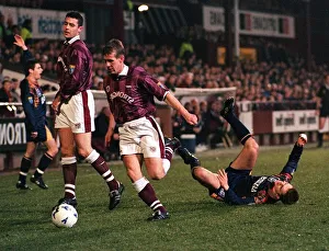 Gary Mackay of Hearts Football Club runs with the ball after tackling Paul Bernard of