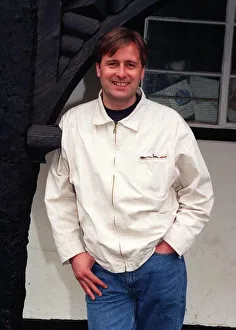 Gary Webster actor standing in archway white jacket denims hand in pocket April 1997