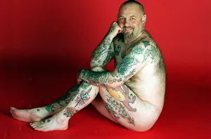 Gavin Boyra - Tattoo man sitting on floor naked tattoos on legs arms and back. April 1997
