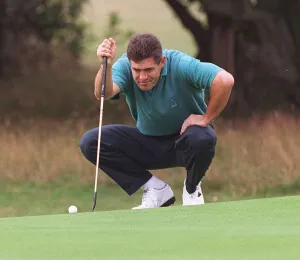 Gavin Hastings rugby player taking a serious look at putt at Dalmahoy golf