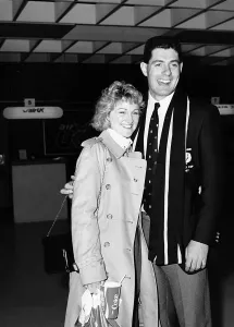 Gavin Hastings rugby player and wife girlfriend standing arm around at airport