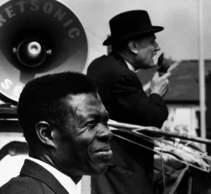 General Election 1970 Enoch Powell canvassing with a microphone with a black man standing