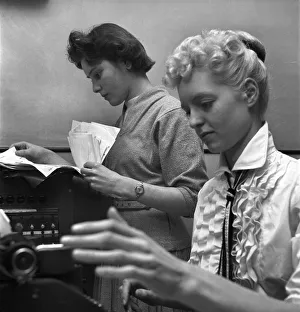 Secretaries Prints: General office scene: Secretary taking notes and answering the phone in a Birmingham