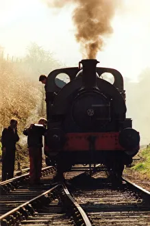 Rural Scene Prints: A general picture of a steam locomotive getting some attention from its engineer