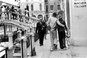 General scenes in Venice. A couple stroll along the narrow Venetian streets