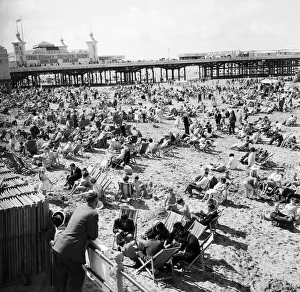 General view showing busy scenes at Blackpool beach in the summer holidays