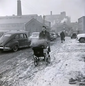A gentleman wheels his sack of coal back from the coal merchant January 1963 The winter