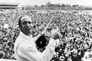 Geoff Boycott with a stump and a glass of champagne after scoring his 100th century in