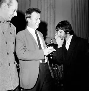 Geoffrey Emerick, an engineer at EMI gets an award from Ringo Starr