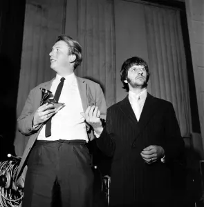 Geoffrey Emerick, an engineer at EMI gets an award from Ringo Starr