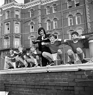 Shorts Prints: George Best with kids from a Childrens Home pictured outside the Imperial Hotel